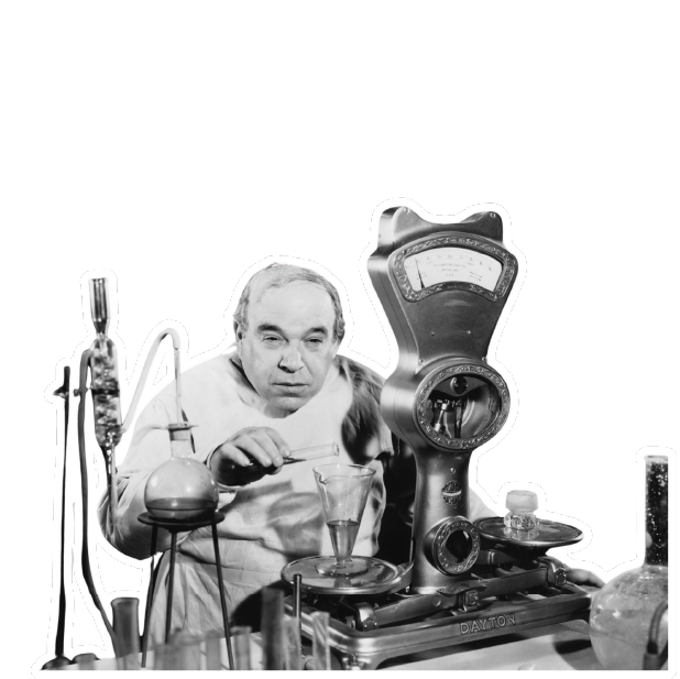 A scientist at a bench of brass instruments and glassware